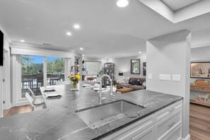 The spacious open-concept living and dining area offers serene harbor views from every corner.