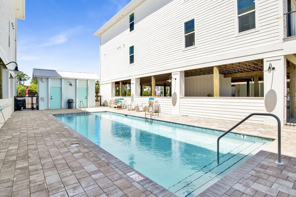 A sunlit oasis framed by modern comforts, inviting you for a refreshing escape.