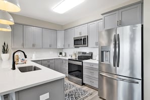 Stylish kitchen where stainless steel meets sleek design, inviting the creation of sumptuous meals and memories.
