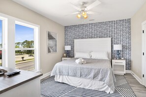 A dynamic bedroom space adorned with a striking feature wall and cool blue accents, promising a tranquil yet trendy escape from the everyday