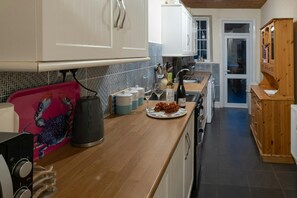 Wall and floor cabinets, kettle, Welsh dresser