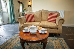 Two seater sofa and coffee table laid for tea