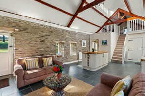 Sofas, coffee table with flowers in the living area