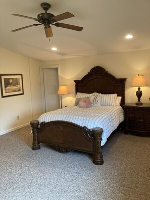 Lofted ceilings and well lit natural light make this bedroom feel very inviting.