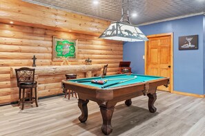 Play a pool game in the game room.