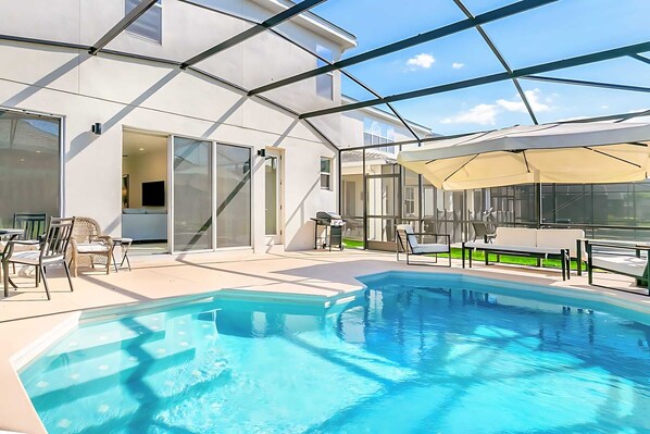 Private Screened-In Patio With Sparkling Pool And Sun Loungers For Relaxation
