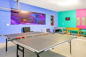 Colorful Games Room Featuring Table Tennis, Foosball, And Air Hockey
