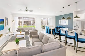 Bright Open Concept Living And Dining Area With Modern Furnishings