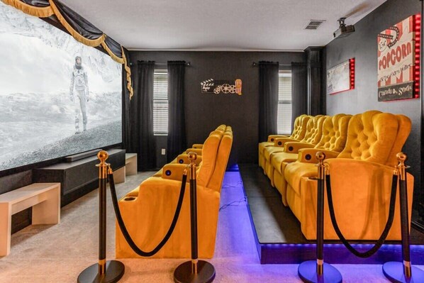 The in house loft movie theatre has a popcorn machine and cool mood lighting.