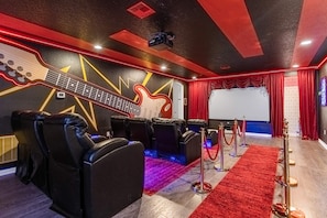 Private Movie Theatre with giant projection screen and cinema style recliners