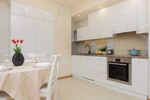 Kitchenette with oven and refrigerator. 