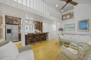 OPEN, AIRY LIVING WITH SEATING FACING KITCHEN ON FIRST STORY