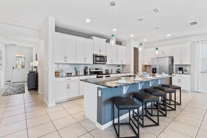 Marvelous and fully equipped Kitchen of the home in Kissimmee - Availability of all necessary kitchen amenities - Sufficient space to store goods - Availability of high chairs with at breakfast bar - Beautiful hanging lamps