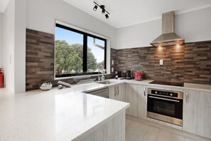 The modern kitchen has plenty of prep space if you want to cook meals.