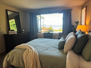 The primary bedroom shares the amazing view, with a queen bed and a blow up queen mattress on request