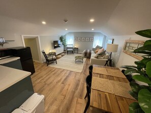 living room, kitchenette, and emergency exit hallway