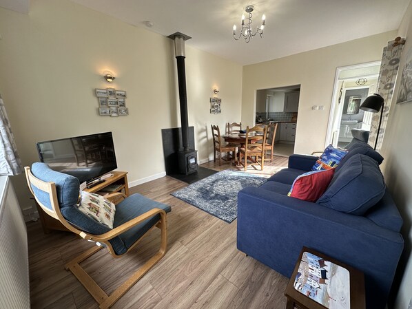 cosy open plan sitting and dining area with log burner
