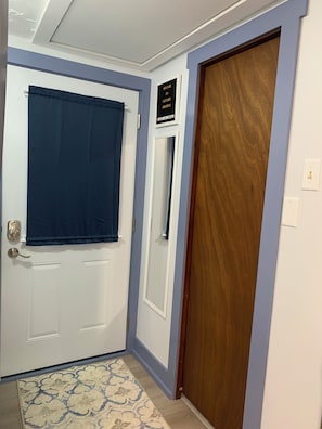 Entry door has an adjustable curtain.  Full length wall mirror