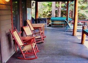 Rear porch overlooks garden and lawn