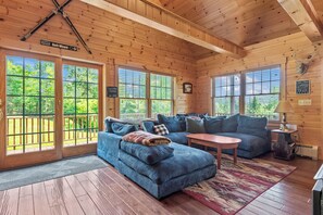 Main floor living area with sliders to deck and hot tub