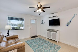 View of front door of unit 1, with comfy leather couch
