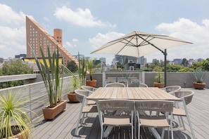 Shared rooftop with expansive city views.