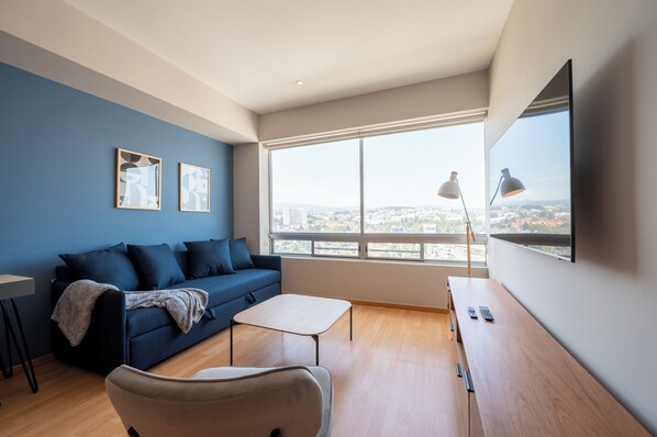 Cozy space featuring a flat-screen TV.





