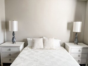 Relax in this spacious primary room with a cozy queen size bed.