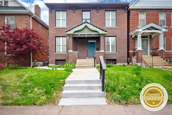 Behold this charming brick house with a vibrant green door and inviting stairs, a perfect blend of elegance and coziness. 🏡🍃 #DreamHome #HouseGoals #GreenDoor