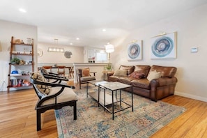 Living room with cozy chairs and a large TV for your comfort and enjoyment.