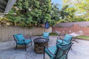 Outdoor place with couch and firepit to relax.