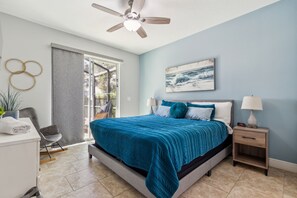 Bedroom with queen bed and ceiling fan; has direct outdoor access