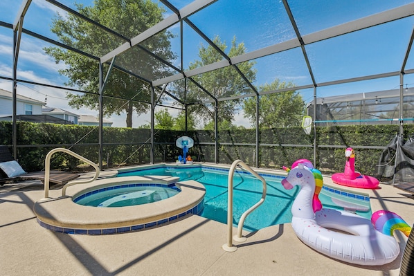 Pool in a pool enclosure with inflatables with a view of the outdoor trees