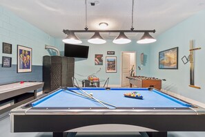 Pool table, hockey, foosball, and board games in the game room