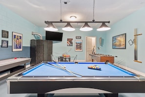 Pool table, hockey, foosball, and board games in the game room