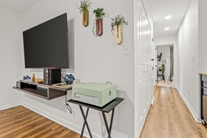 Enjoy music on a Modern Corsley Bluetooth Record Player, and hand selected records for music lovers, or enjoy a 65 inch smart TV to watch your favorite show.