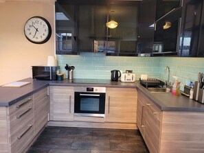 Open plan kitchen with induction hob, dish washer, kettle, toaster, microwave, cafetiere, crockery, rice cooker etc. Tea and coffee provided.
