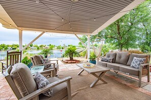 Our cozy patio beckons with ample seating and a swinging escape, all set against the backdrop of breathtaking waterfront vistas.