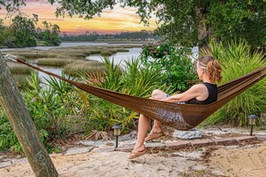 Find tranquility in the gentle sway of a hammock by the water's edge.