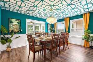 Gather around our grand table in a dining room adorned with dramatic ceilings, where every meal comes with a stunning view of the water's edge.