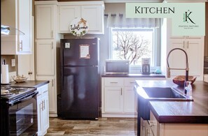 Full size fridge and freezer, stove, and oven.