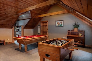 Game room on upper level; small library, foosball table, pool table, futon.