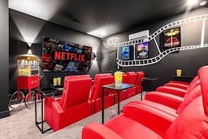 Movie theater with surround sound, reclining seats, popcorn machine!