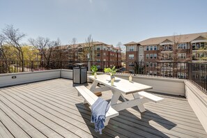 Communal rooftop patio featuring outdoor dining and city views.