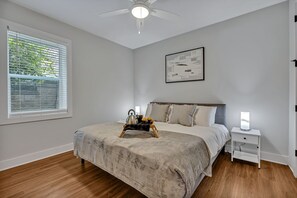 Primary Bedroom featuring a King bed with a Smart TV, bedroom furnishings, and an ensuite Primary Bathroom.