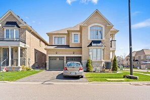 Garage entrance on side view including parking space.
