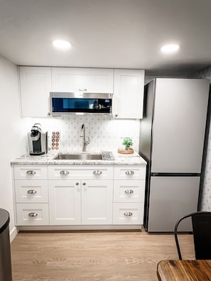 Kitchenette with Keurig and microwave. There’s no stove.