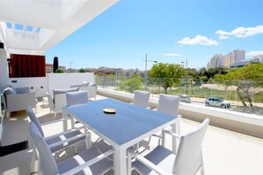Large and sunny terrace with outdoor seating and dining table for six guests
