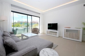 Modern and bright lounge with comfortable seating and terrace access