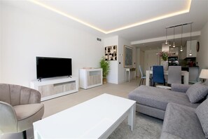 Another picture of the lounge area with dining area and open kitchen to the rear